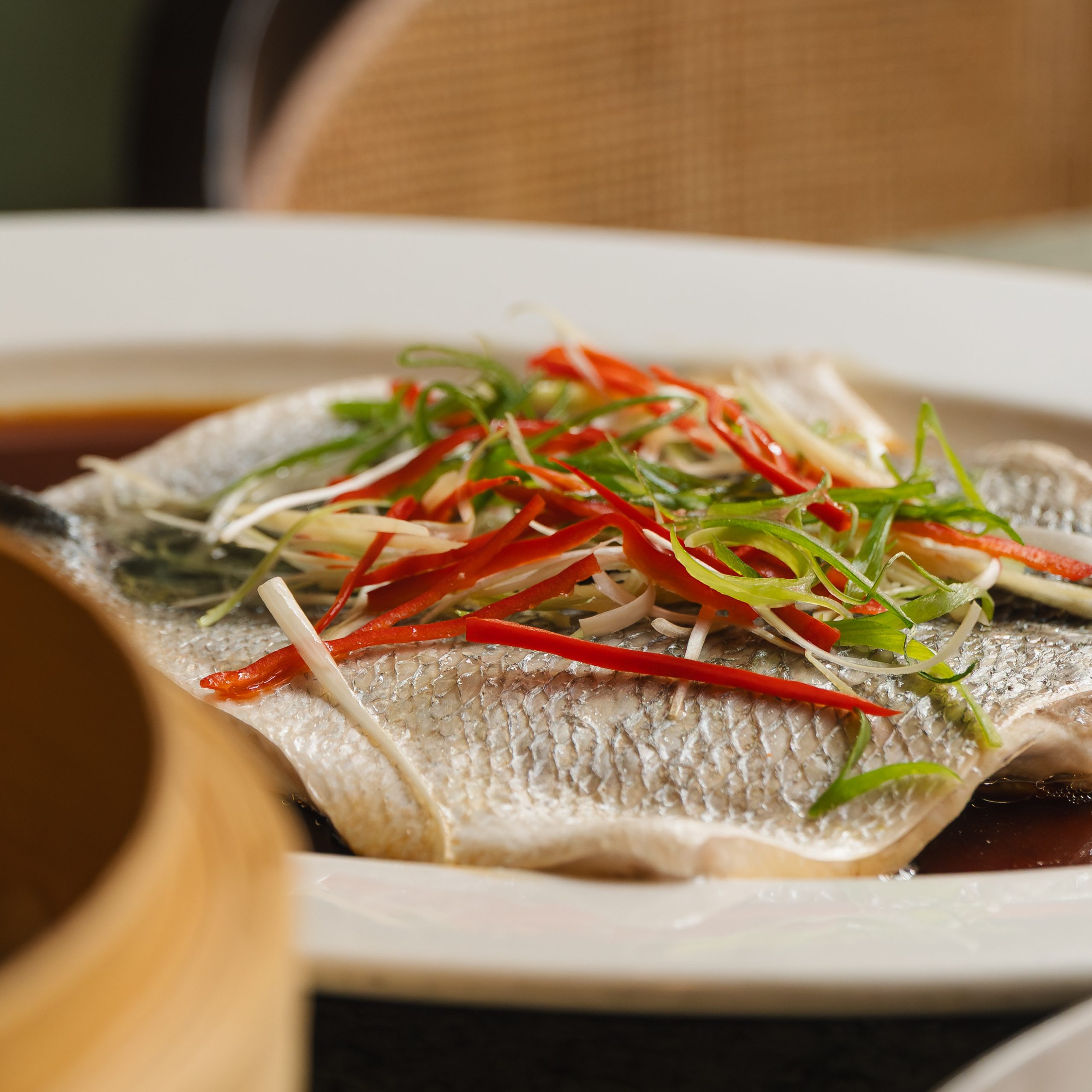 Steamed sea bass with ginger, spring onions and red chilli at House of Ming Chinese restaurant London