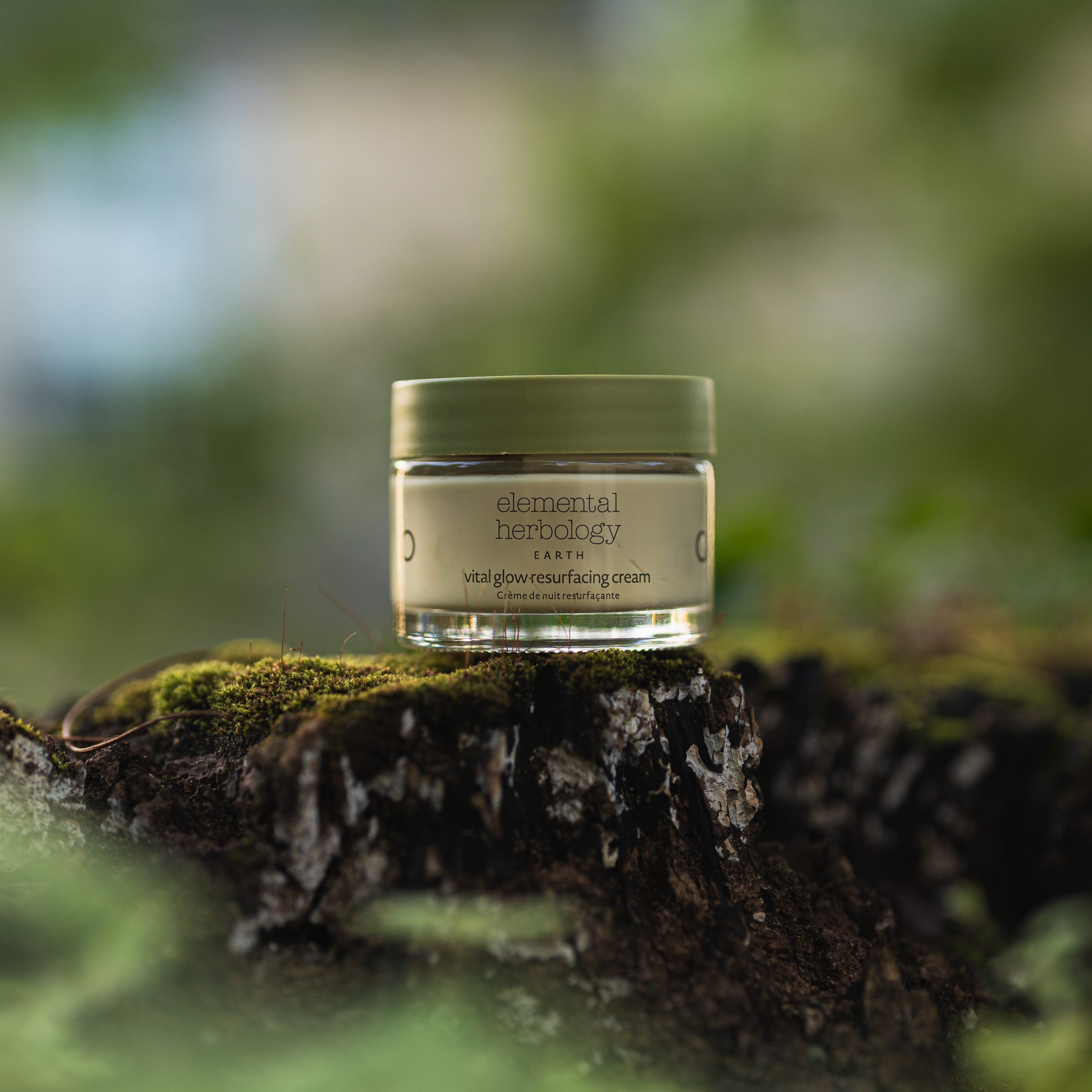 Elemental Herbology Vital Glow Resurfacing Cream on moss in natural forest setting luxury skincare